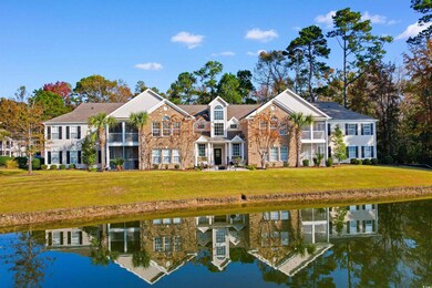 Rear view of property with a lawn and a water view
