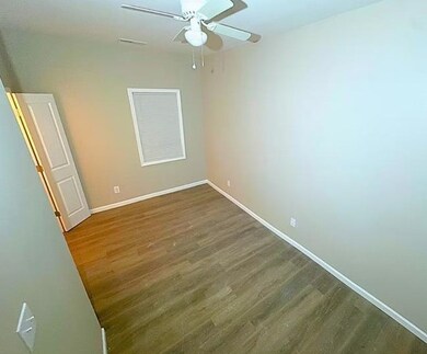 Stairway featuring a ceiling fan and wood finished floors