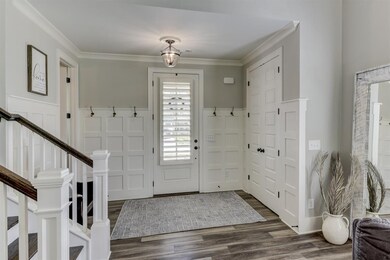 Foyer with paneling and hooks