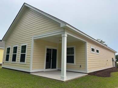 Rear view of house with a patio area and a lawn