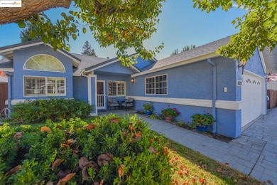 View of front of home featuring stucco siding, a garage, a patio area, and roof with shingles