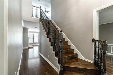 Staircase featuring a towering ceiling, ornamental