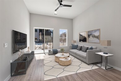 Living room featuring a ceiling fan and wood fini