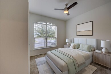 Carpeted bedroom featuring a ceiling fan and base