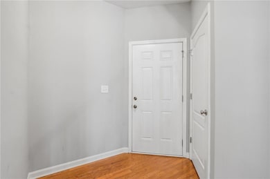 Hall featuring light wood-type flooring and basebo