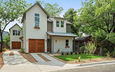 View of front of property featuring a garage, stu