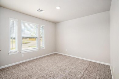 Bright and inviting!  This cozy bedroom features three large windows that let in plenty of natural light, creating a warm and welcoming atmosphere. Perfect for relaxation or a home office!