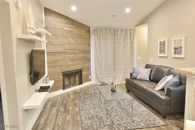 Living area with wood finished floors, vaulted cei