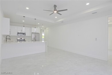 Unfurnished living room with a raised ceiling, cei