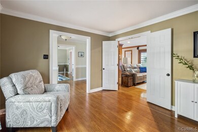 Living area with crown molding and hardwood / wood