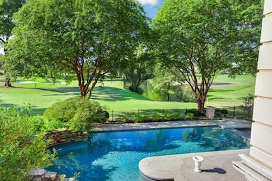 View of pool featuring golf course view and a fenced backyard