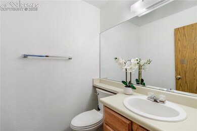 Bathroom featuring vanity, toilet, and a wall unit