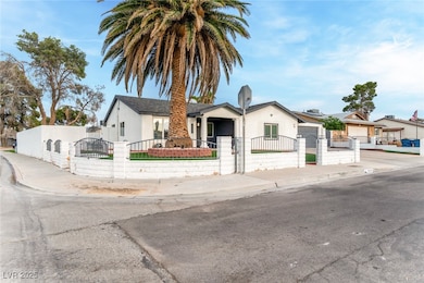 Bungalow featuring a fenced front yard, a gate, and stucco siding