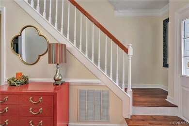 Welcoming Foyer with crown molding and chair rail