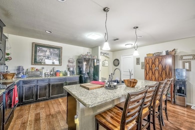 Kitchen with an island with sink, decorative light