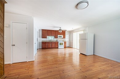 Living room with view of hall closet and kitchen