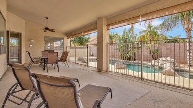 Large covered patio with pool fence