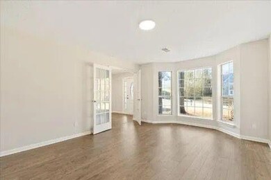 Empty room with baseboards and wood finished floors