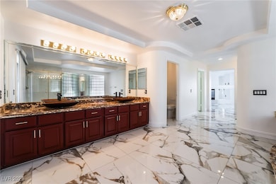 Full bath featuring visible vents, a tray ceiling,