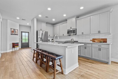 Kitchen featuring visible vents, a sink, stainles
