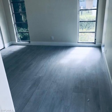 Empty room featuring baseboards and wood finished floors