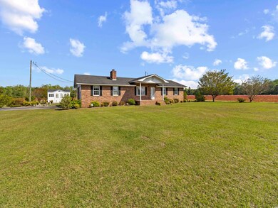 View of front of house with a chimney, a front law