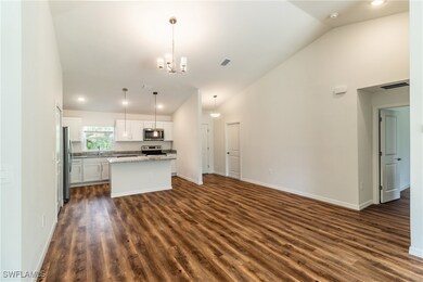 Kitchen with visible vents, a kitchen island, stai