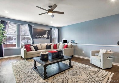 Living room featuring dark hardwood / wood-style floors and ceiling fan