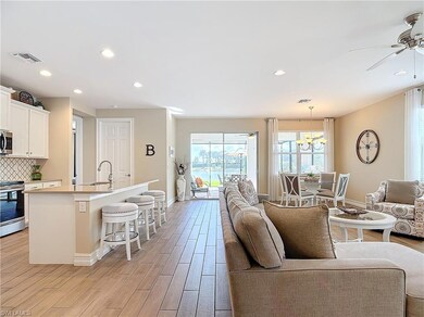 Living room featuring ceiling fan with notable cha