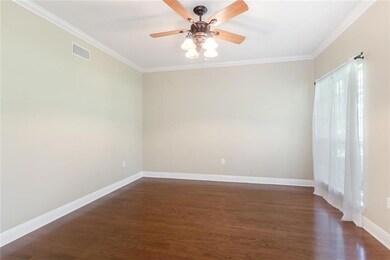 Study/office of the foyer with wood floors.