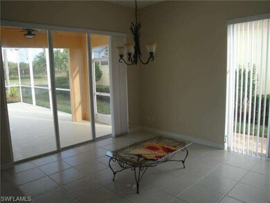 Dining area overlooking screened lanai and lake.