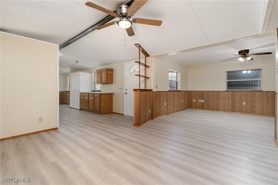 Unfurnished living room featuring ceiling fan, lig