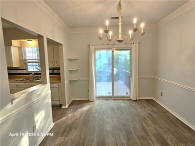 Unfurnished dining area with a chandelier, dark wo