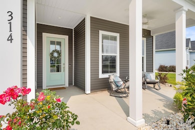 Entrance with covered porch and ceiling fan