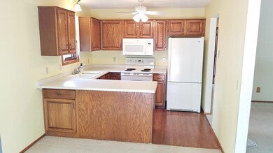 Kitchen has raised panel oak cabinetry, oak hardwo