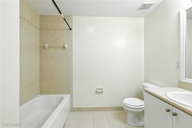 Full bath featuring tile patterned flooring, vanit