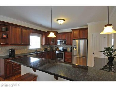 Kitchen. Exceptionally large kitchen with upgraded appliances and cabinetry, granite counters and hardwood floors. Look at that counter space!