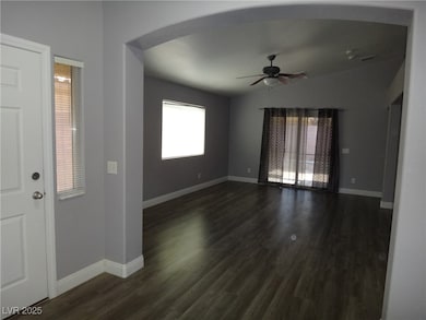 Entryway featuring arched walkways, dark wood fini