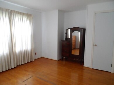 Main floor bedroom w wood floors