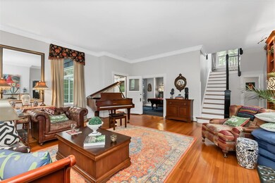 The living room has access to the office (left), billiards room, the second staircase, back hall and library/music room. Flow in the home is wonderful for entertaining!