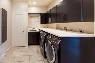 1st Floor Laundry with quartz counters, sink, and