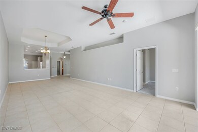 Unfurnished living room with a ceiling fan, a tray