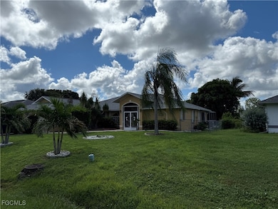 View of front of property with a front yard, stucco siding, and a sunroom