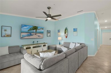 Living room with light tile patterned floors, crown molding, a ceiling fan, recessed lighting, and baseboards