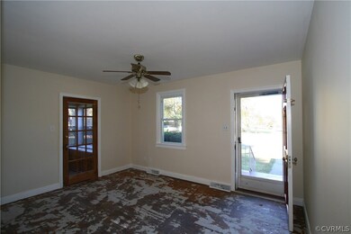 Living room with glass pane door that opens to the sunroom.
