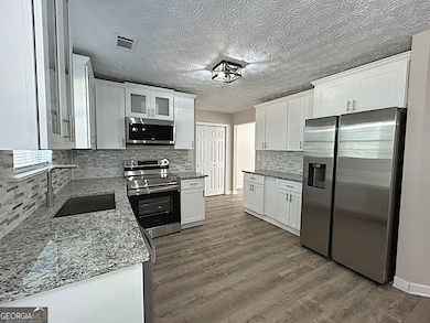 Beautiful, Bright and Open kitchen with new cabinets, pantry, granite countertops and stainless steel appliances