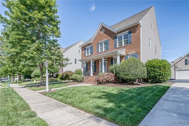 View of front of house featuring brick siding, a porch, and a front yard