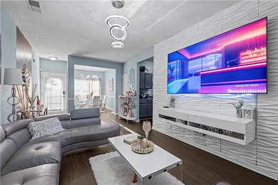 Living area featuring a textured ceiling, visible 
