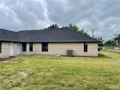 View of side of home with a yard and central AC unit