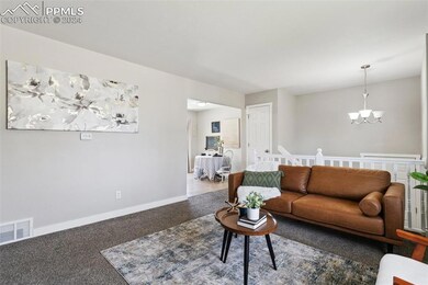 Carpeted living room featuring an inviting chandel